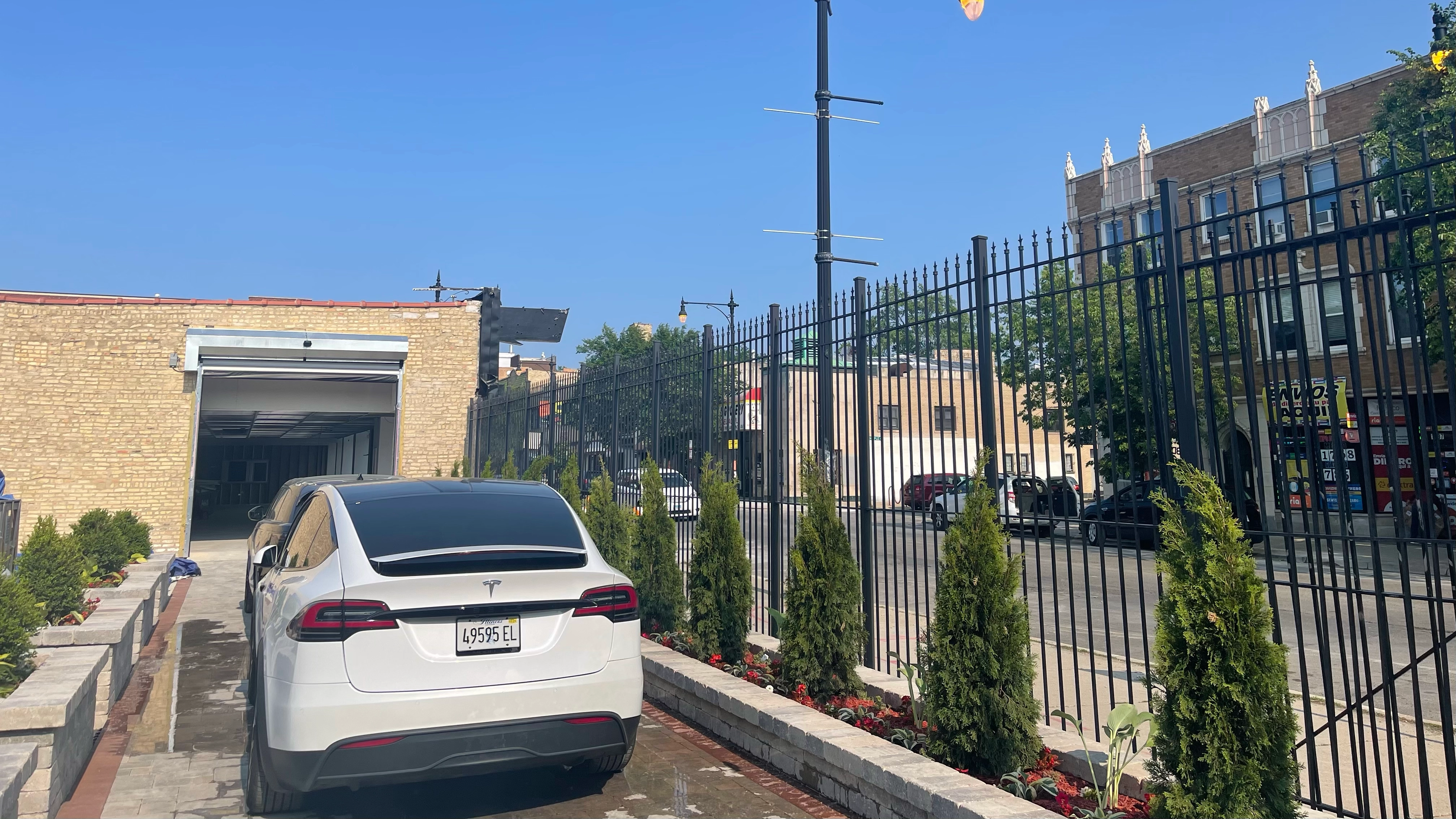 Brick driveway with a Tesla on it